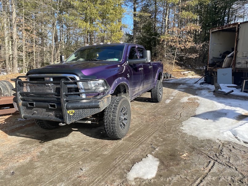 Ram 2500 on a snowy lot, freshly tinted glass cutting winter glare off the snowpack.