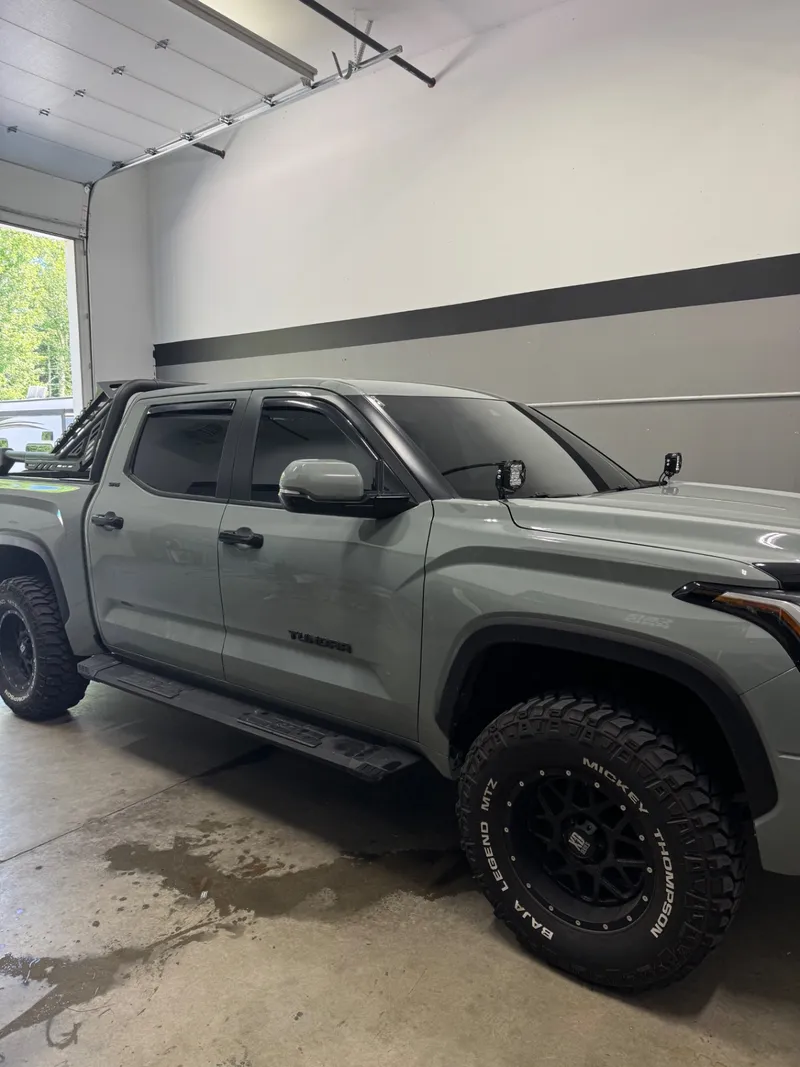 Lunar Rock Toyota Tundra crew cab in the bay with matched tint across the cab glass.