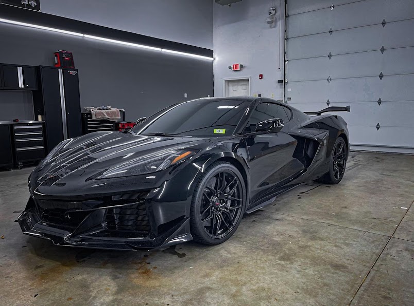 Corvette Z06 with ceramic tint on the side and rear glass inside a clean detail bay.