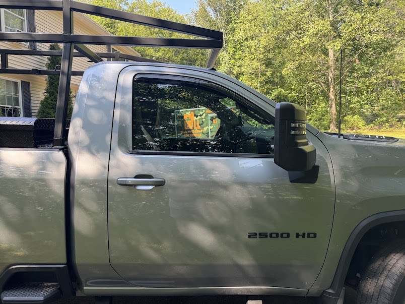 Silverado 2500HD front door glass tinted for daily cab-heat control on job sites.