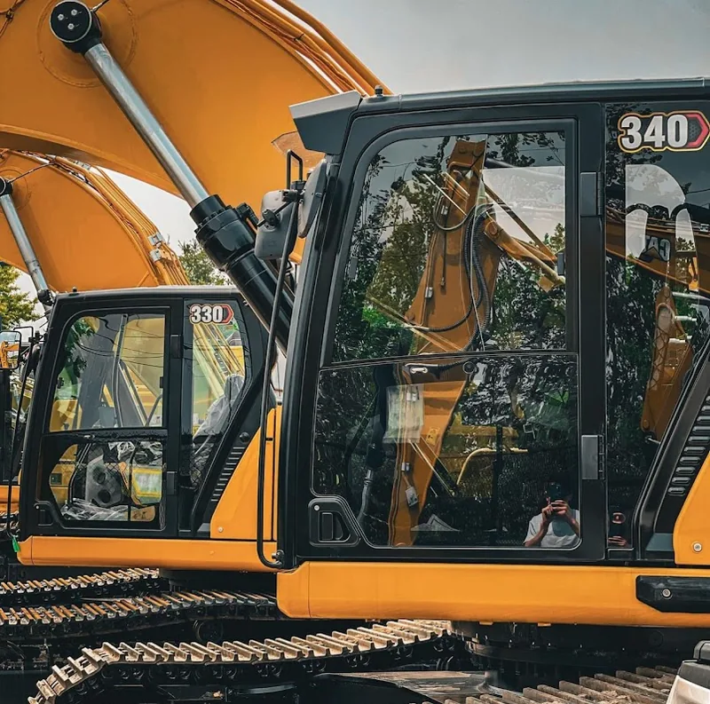 Excavator cab glass filmed for heat and glare control on a New Hampshire job site.